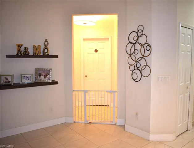 Hallway with light tile patterned flooring