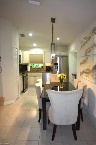 Tiled dining room featuring sink