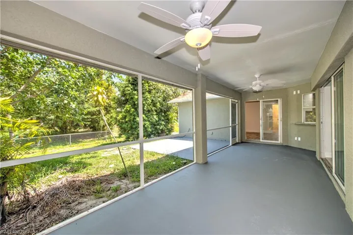 Unfurnished sunroom with a ceiling fan