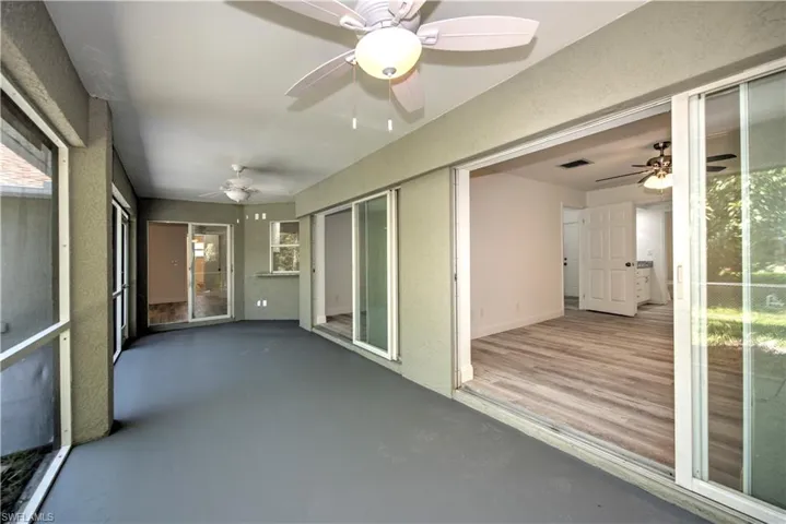 Unfurnished sunroom featuring visible vents and ceiling fan