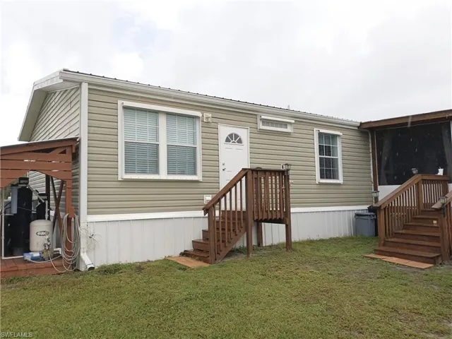 View of front of home featuring a front lawn and stairs