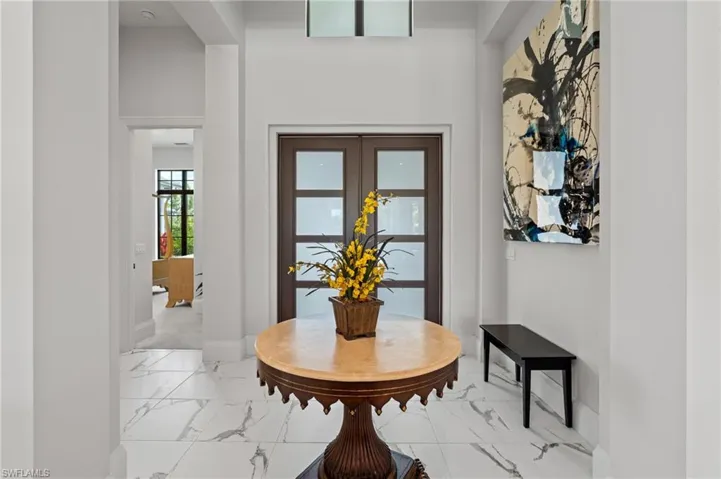 Foyer entrance with light marble finish floors