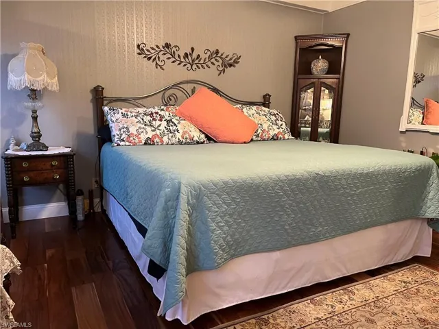 Bedroom with hardwood / wood-style flooring