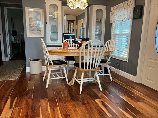 Dining room with hardwood / wood-style flooring and crown molding