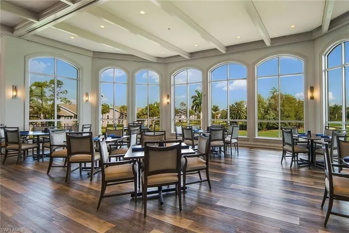 Dining space featuring dark hardwood / wood-style floors, a healthy amount of sunlight, and beam ceiling