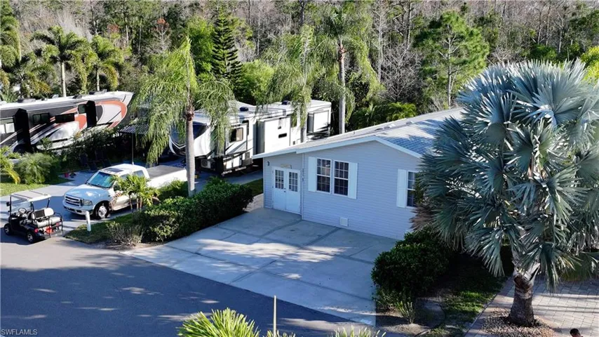 View of side of property featuring concrete driveway and crawl space