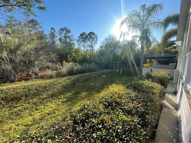 View of green lawn with a sunroom