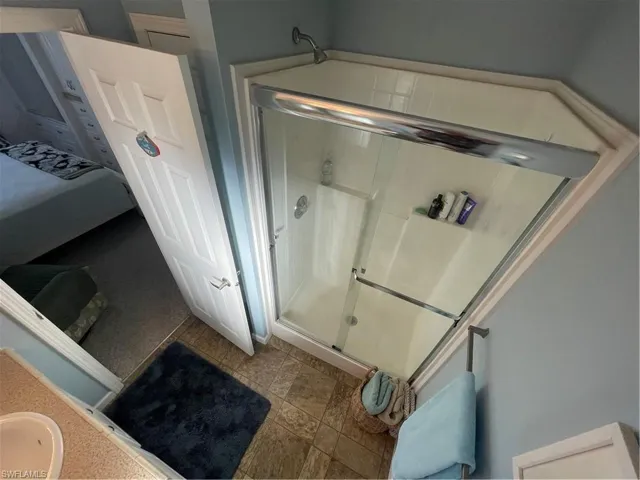Bathroom with a shower stall and a sink