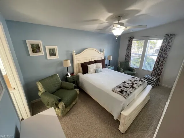 Bedroom with ceiling fan and carpet floors