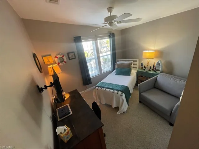 Bedroom featuring light colored carpet and a ceiling fan