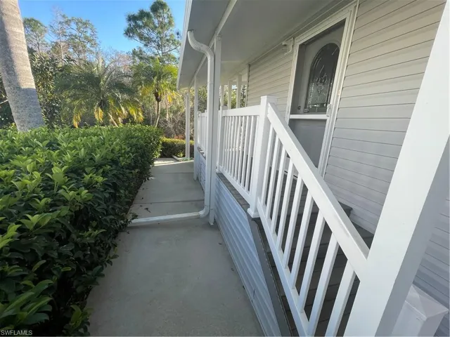 View of property exterior featuring covered porch