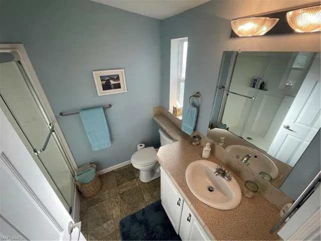 Bathroom with a stall shower and vanity