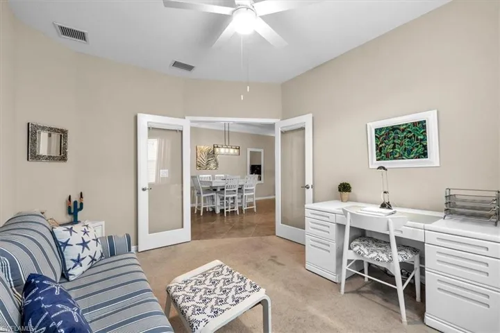 French doors in den with desk and couch