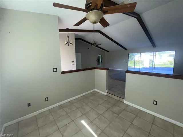 Unfurnished room with light tile patterned flooring and a ceiling fan