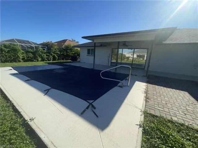 View of pool with ceiling fan and a patio