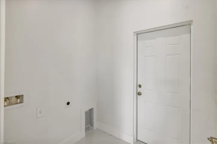 Washroom featuring hookup for a washing machine, laundry area, baseboards, marble finish floor, and electric dryer hookup