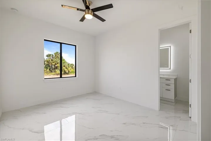 n.3 bedroom with a ceiling fan, marble finish floor, and baseboards