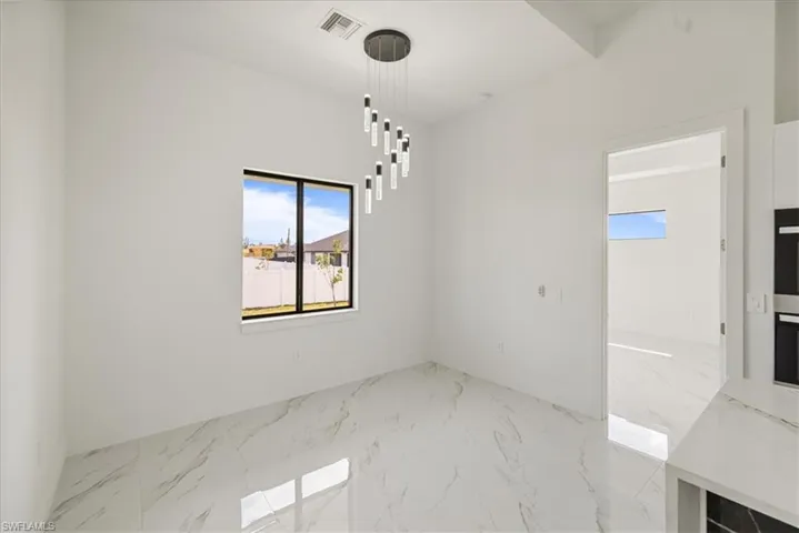 dining area featuring marble finish floor, visible vents, and baseboards