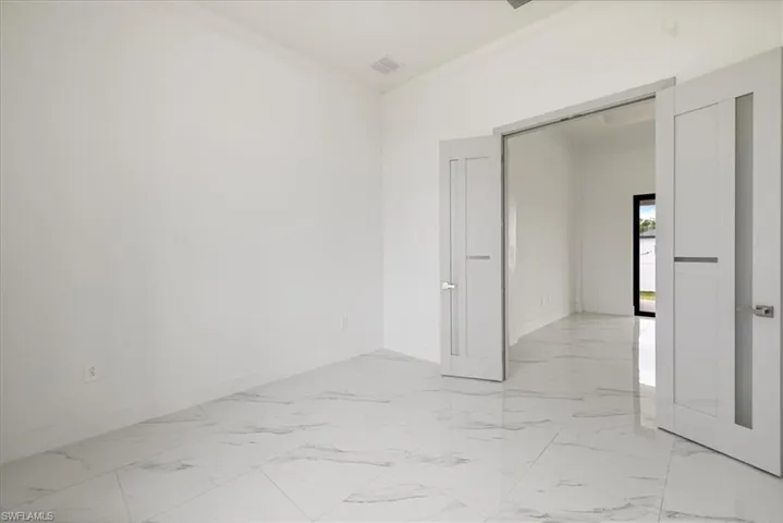 n.1 bedroom with marble finish floor, visible vents, and baseboards