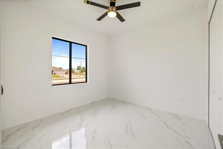 n.2 bedroom with ceiling fan, marble finish floor, and baseboards