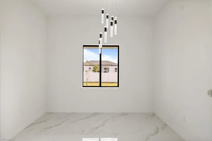 dining area  with marble finish floor and baseboards