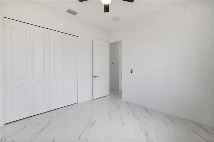 n.2 bedroom featuring marble finish floor, a closet, visible vents, a ceiling fan, and baseboards