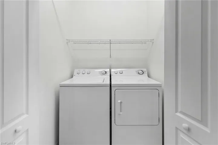 Washroom featuring washing machine and dryer