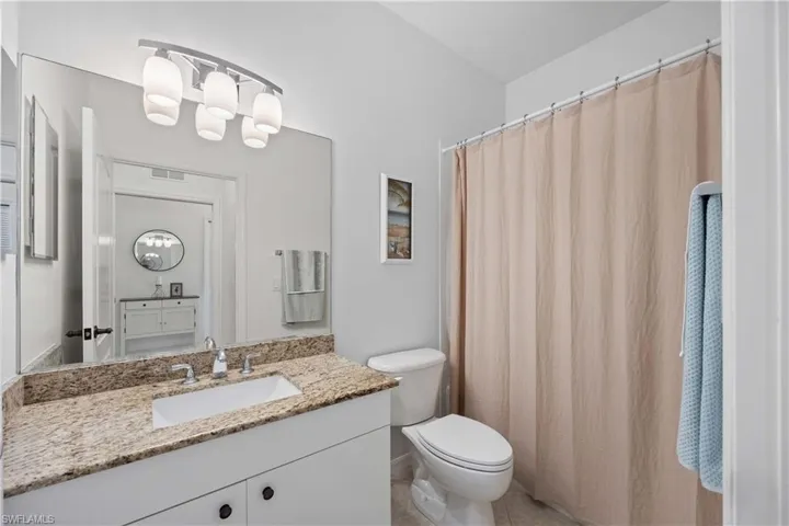 Bathroom with tile patterned floors, vanity, and toilet