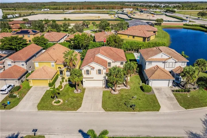 Birds eye view of property with a water view