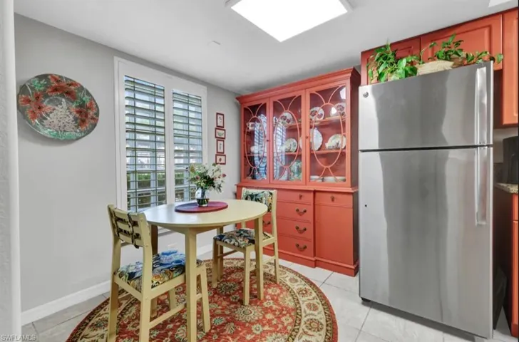 Dining space featuring light tile patterned floors