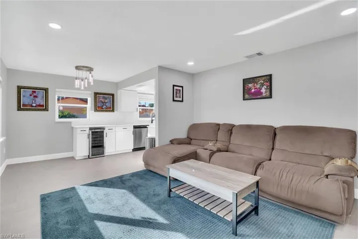 Living area with beverage cooler and recessed lighting