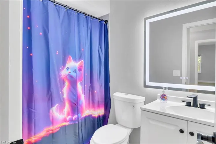 Bathroom featuring vanity and toilet