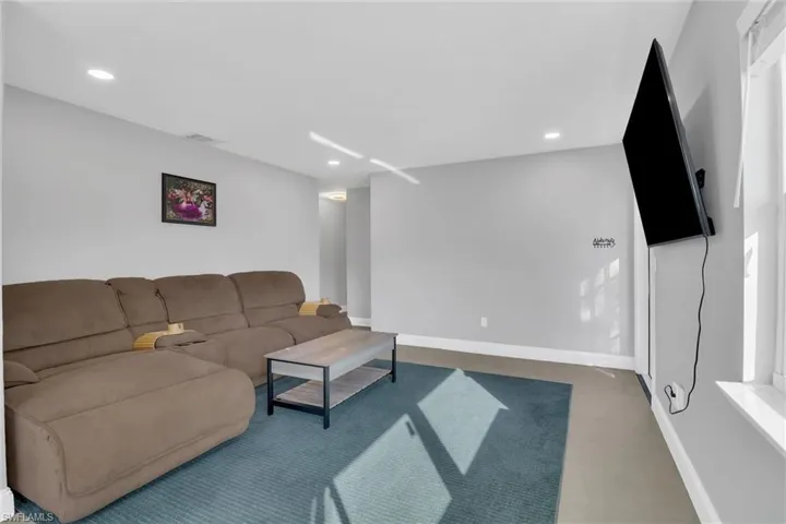 Living room with baseboards and recessed lighting