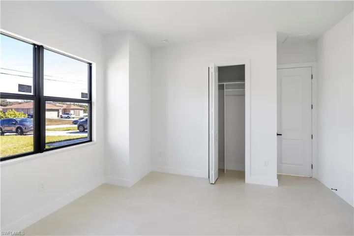 Unfurnished bedroom with a closet and light tile patterned floors