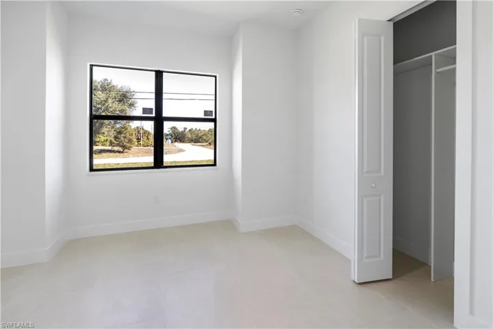 Unfurnished bedroom with baseboards and a closet