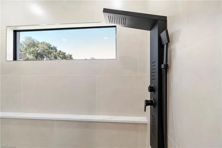 Full master bathroom with a tile double shower and plenty of natural light