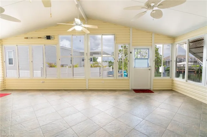 Unfurnished sunroom with a ceiling fan