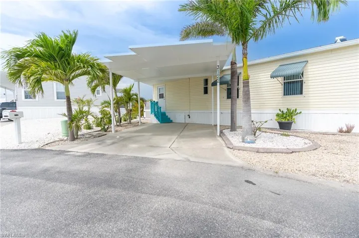 Manufactured / mobile home with an attached carport and driveway