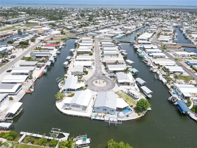 Aerial view of property's location with a large body of water and nearby suburban area