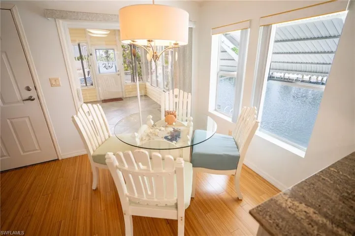 Dining room with a chandelier, healthy amount of natural light, and light wood finished floors