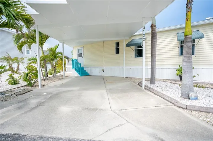 View of patio with an attached carport and entry steps