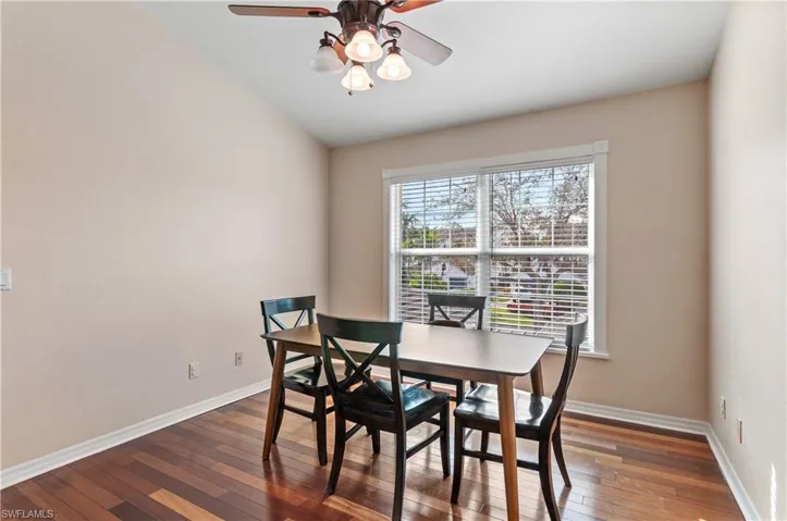 Dining room featuring dark wood-type flooring and a ceiling fan