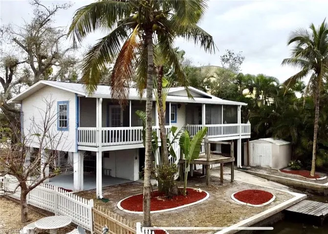 Aerial drone view of the back of the property.  The wooden dock used to have a hot tub on top of it.  The storage shed is large enoug to store many boating items, fishing poles or bicycles.