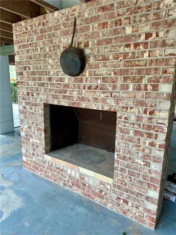 Wood burning brick fireplace on ground level for neighborhood gatherings.