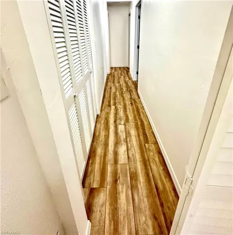 Long hallway with extra storage leading to the other two bedrooms