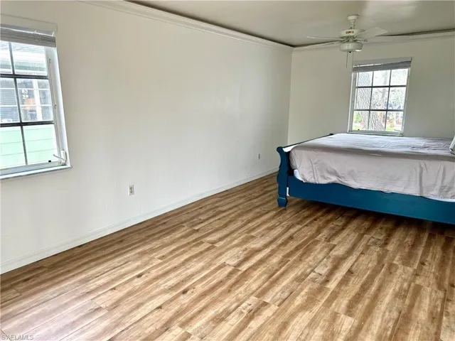 Two windows and a walk in closet, French doors that open up to a balcony that overlooks the Gulf Access Canal