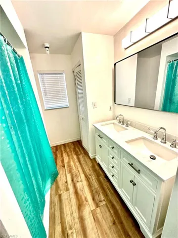 Newer cabinets and floors with dual faucets and sink,