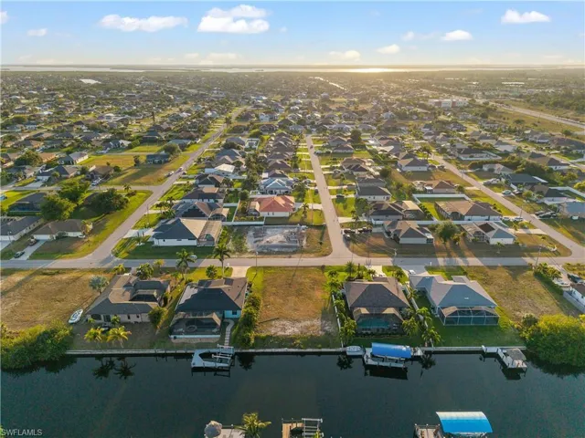 Aerial overview of property's location featuring a large body of water and nearby suburban area
