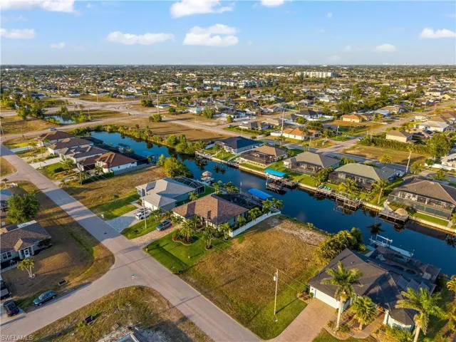Aerial view of residential area featuring a nearby body of water
