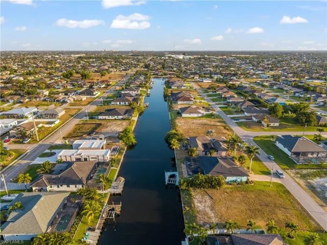 Aerial overview of property's location featuring a large body of water and nearby suburban area